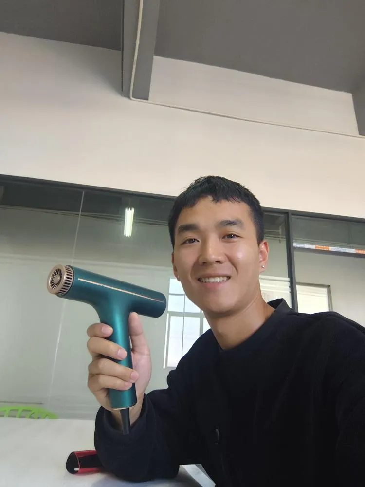 Our General Manager Holding a High-Quality Hair Dryer Appearance Prototype for Customer Review