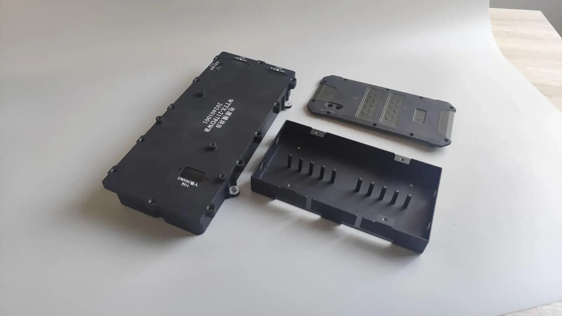 A CNC machined Aluminum 6061 component with a black hard-anodized finish for superior wear resistance, featuring high-contrast white silk-screened logos and text.