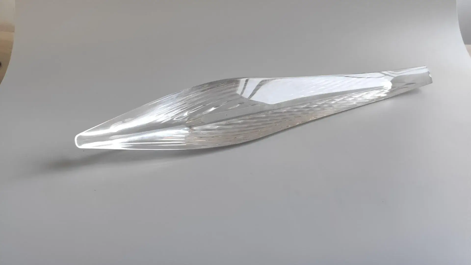 An optical-grade PMMA light guide for automotive applications, CNC machined and high-polished to achieve 100% transparency and flawless light transmission.