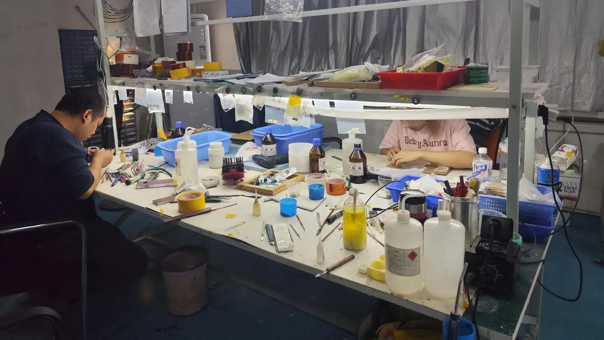 A skilled technician performing precision manual deburring on a CNC machined component to ensure smooth edges and safe handling.