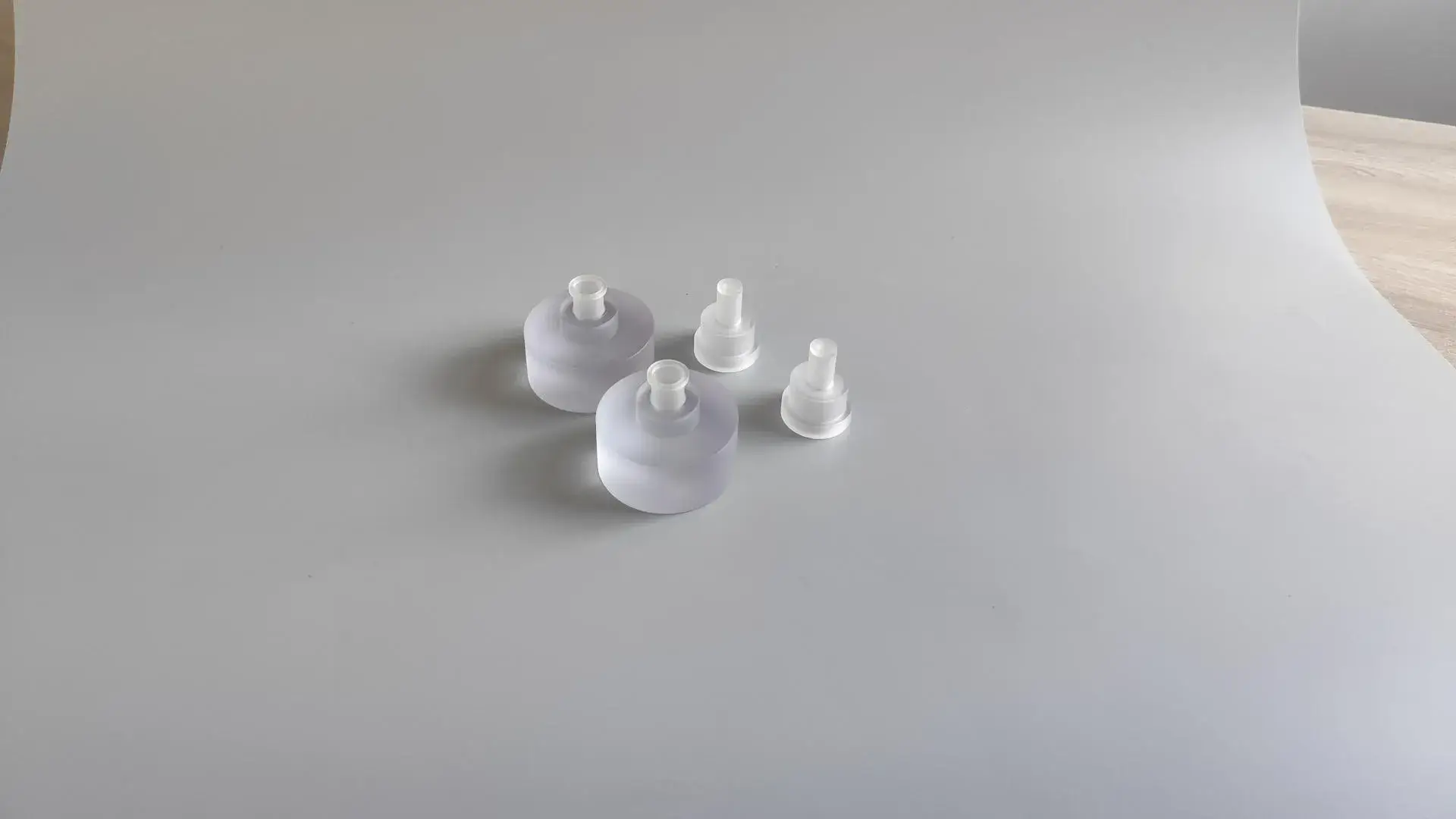 A precision CNC turned PC (polycarbonate) part, hand-polished to a semi-transparent finish to showcase internal clarity and surface smoothness.