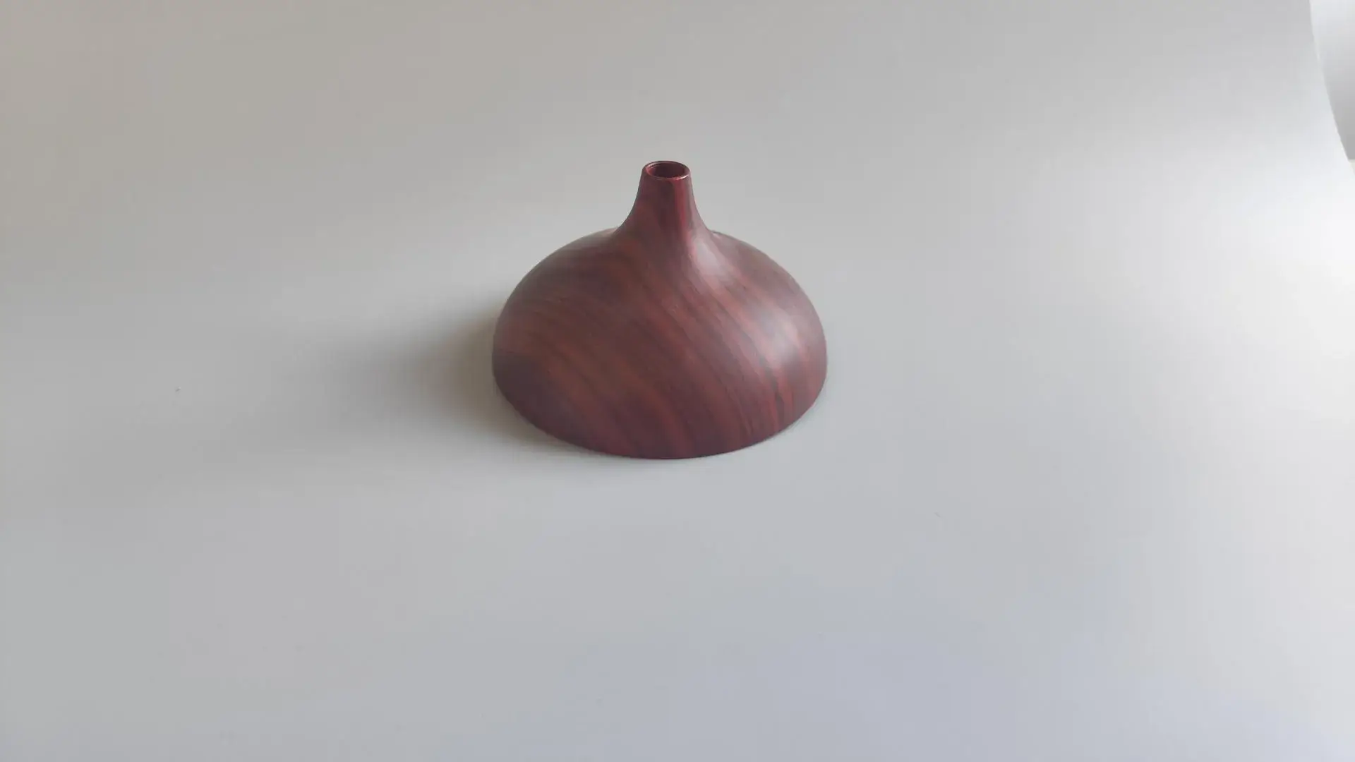 A CNC machined prototype finished with high-definition wood grain water transfer printing and a polished top coat, showcasing our ability to apply realistic natural textures to complex geometries.